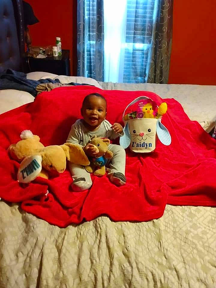 Z'Aidyn is registered to the contest to win money with this photo: bed_sheet, bedding, child, comfort, couch, curtain, event, fun, hat, interior_design, lamp, linens, person, pillow, plush, room, stuffed_toy, teddy_bear, textile, toy