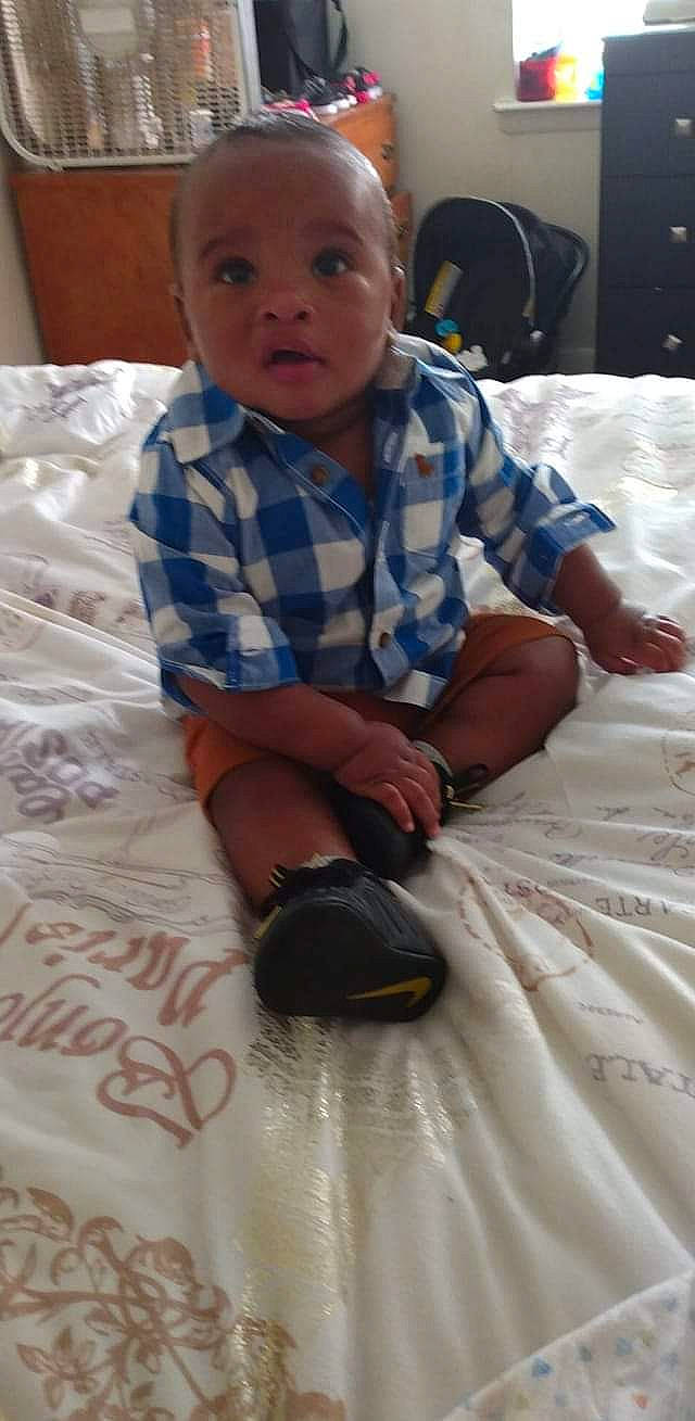 Z'Aidyn joined the competition — help win amazing prizes! arm, baby, baby_toddler_clothing, black, cheek, child, comfort, finger, flooring, fun, hairstyle, linens, mouth, person, room, sitting, skin, sleeve, textile, toddler