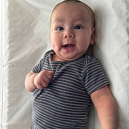 Jacob joined the competition — help win amazing prizes! baby, cheeks, child, cute, expressive, face, hand, happy, indoors, infant, lying_down, onesie, person, portrait, skin, smiling, soft_light, striped_clothing, white_background, young