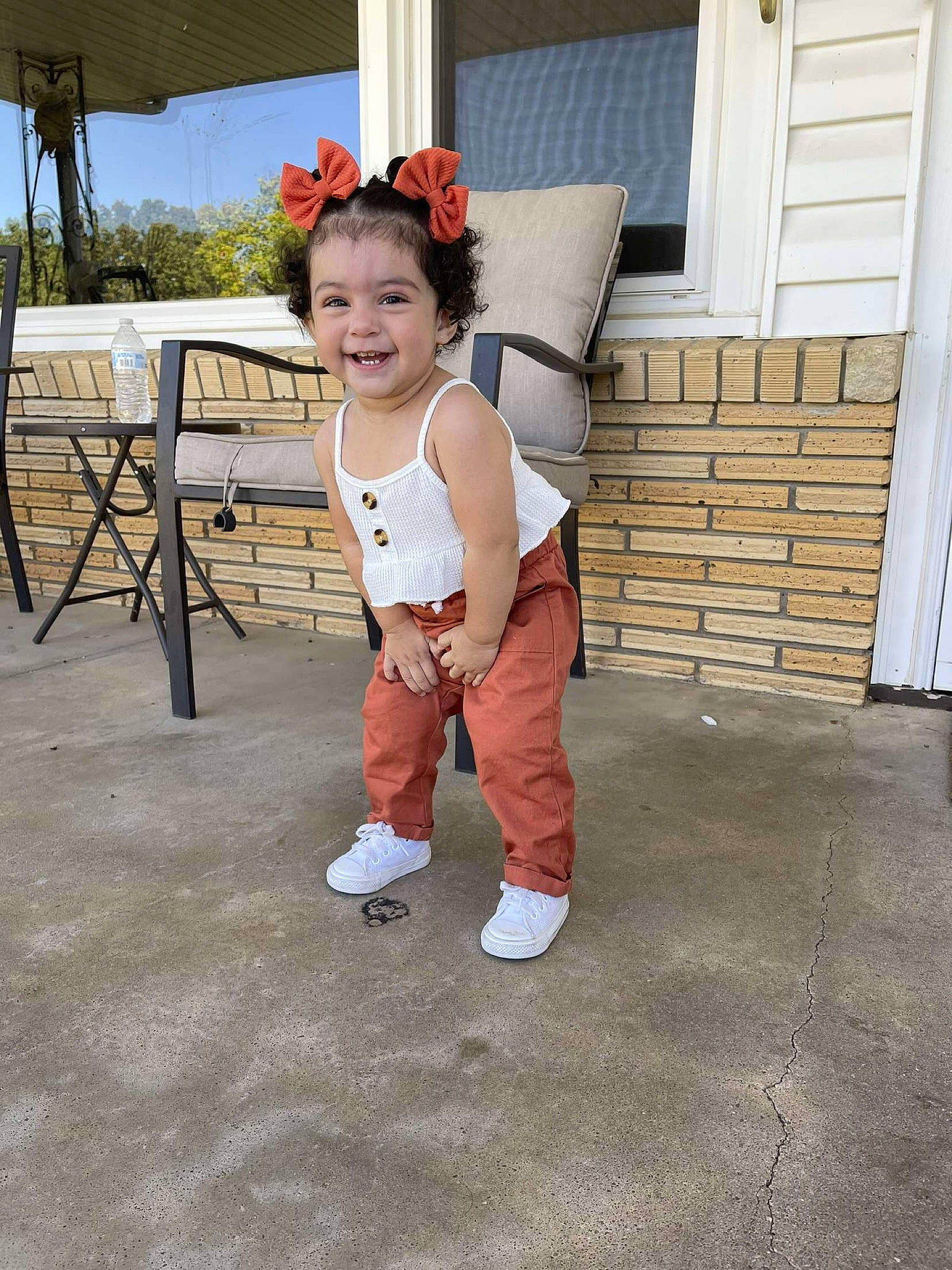 Ehlani is registered to the contest to win money with this photo: baby, baby_toddler_clothing, costume, door, event, fashion_accessory, flooring, happy, hat, joy, leg, leisure, outdoor_furniture, person, personal_protective_equipment, sitting, sleeve, smile, table, toddler