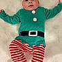 Aaron participe au concours pour gagner de l'argent avec cette photo : baby, infant, child, festive, elf_costume, striped_pants, red_and_white, green_shirt, hat, pom_poms, lying_down, fluffy_surface, cute, holiday, christmas, costume, smiling, indoors, person, portrait