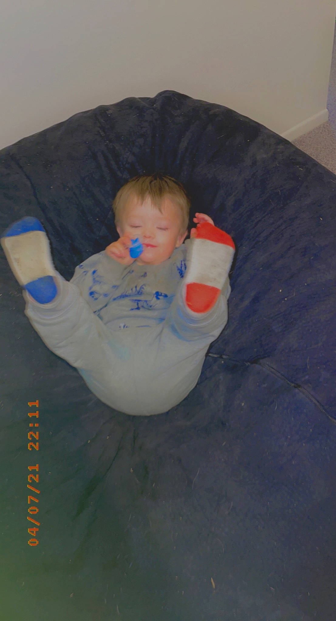 Sebastian is registered to the contest to win money with this photo: baby, baby_toddler_clothing, child, circle, comfort, electric_blue, flooring, fun, linens, person, personal_protective_equipment, sitting, sleeve, t_shirt, toddler