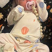 Opaline joined the competition — help win amazing prizes! baby, infant, pacifier, pacifier_clip, headband, bow, onesie, hot_air_balloon, blanket, pattern, booties, mittens, beads, portrait, close_up, cozy, soft_fabric, newborn_style, indoors, sleepwear