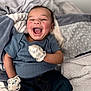 Kashmier is registered to the contest to win money with this photo: baby, infant, smile, laughing, mittens, blanket, bedding, jeans, onesie, mouth_open, cheeks, portrait, bed, cozy, joyful, hand, eyes, hair, skin, cute