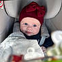 Alice participe au concours pour gagner de l'argent avec cette photo : baby, infant, car_seat, blanket, red_hat, bow, blue_eyes, face, child, clothing, seatbelt, soft_toy, comfort, indoor, portrait, closeup, cute, small_hands, warm, rest