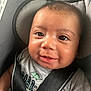 Asher joined the competition — help win amazing prizes! baby, child, car_seat, smile, happy, face, infant, clothing, straps, seat_belt, dinosaur, tshirt, closeup, cute, young, indoors, person, head, portrait, seat