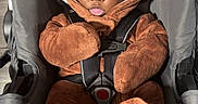 Tremeire is registered to the contest to win money with this photo: baby, child, car_seat, brown_onesie, hood, ears, straps, seatbelt, cute, infant, indoors, portrait, looking_at_camera, fuzzy_clothing, adorable, small_hands, sitting, baby_clothing, secure, child_safety