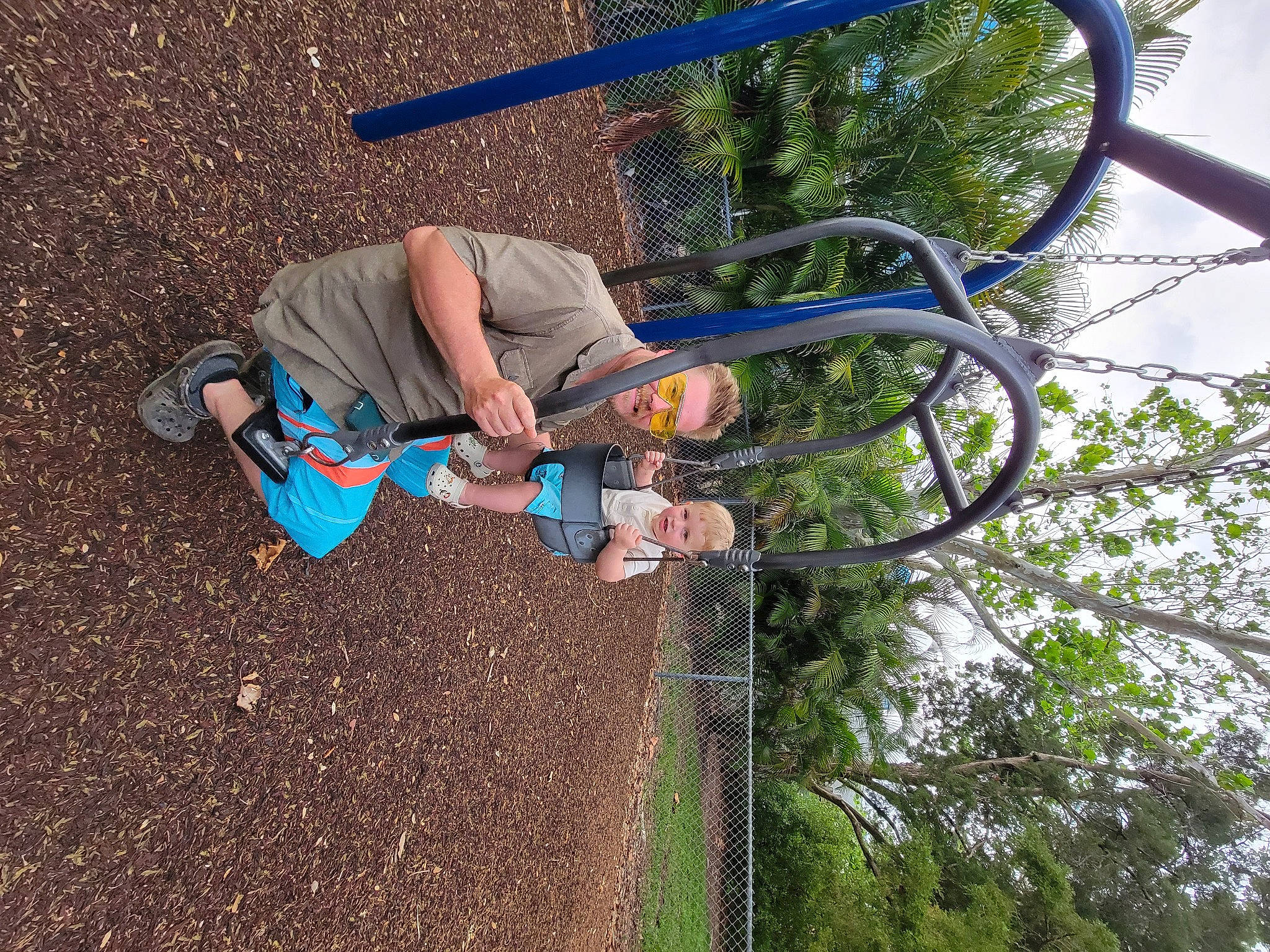 Carter is registered to the contest to win money with this photo: asphalt, bicycle_handlebar, bicycle_tire, concrete, fun, grass, leisure, people_in_nature, person, plant, pole, recreation, shrub, sky, soil, street_light, tire, tree, walking_shoe, woody_plant