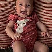 Holloni joined the competition — help win amazing prizes! baby, infant, smiling, onesie, pink, polka_dot, bunny, pillow, striped, cute, happy, child, lying_down, home, indoor, face, arms, legs, soft, cozy