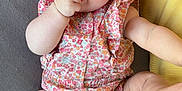 Alina participe au concours pour gagner de l'argent avec cette photo : baby, infant, child, blue_eyes, romper, floral_pattern, hand, fist, legs, kicking, bed, pillow, cushion, skin, cute, playful, lying_down, indoors, closeup, person