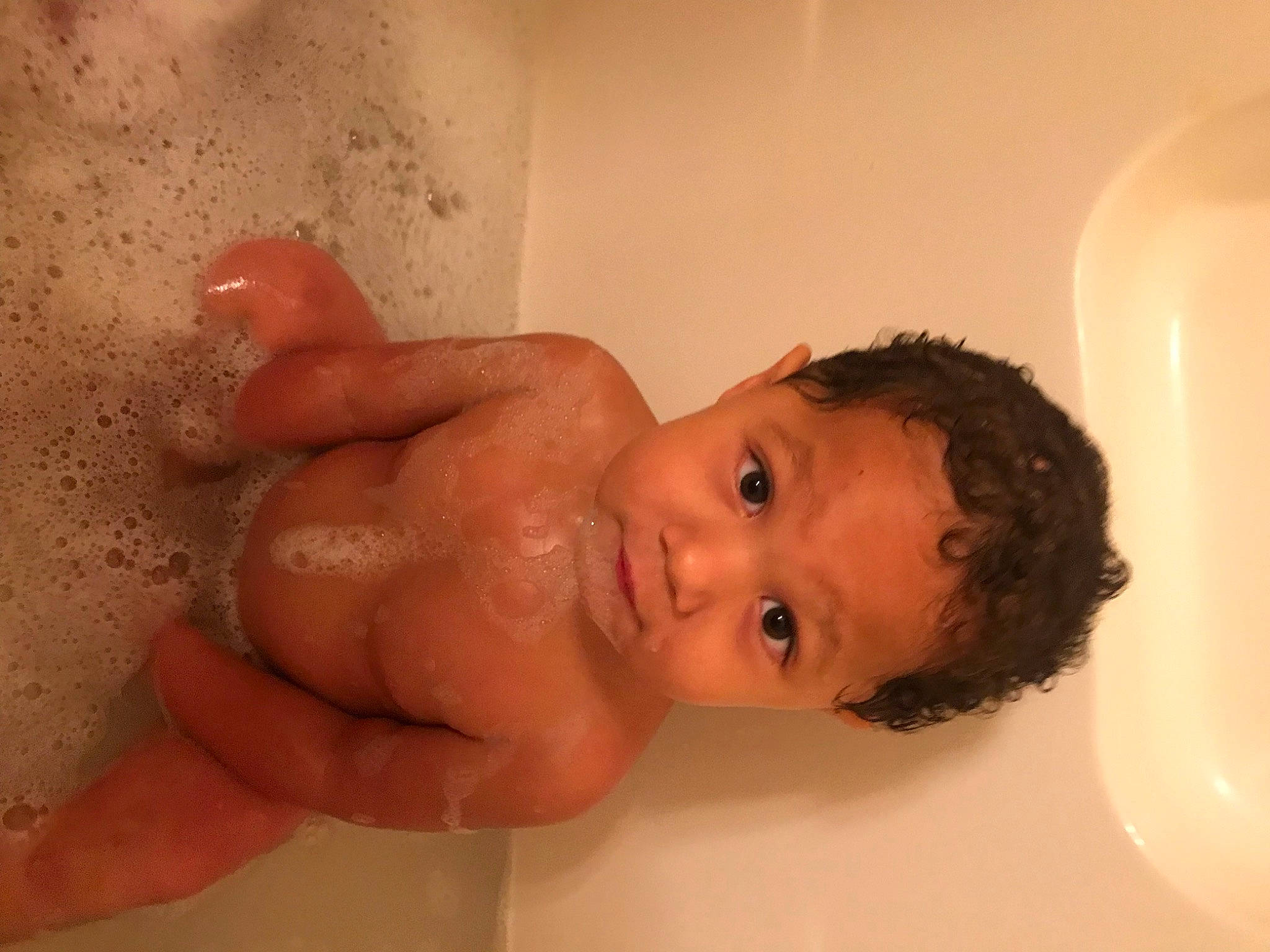 Eli is registered to the contest to win money with this photo: baby_bathing, bathing, bathroom, bathtub, cheek, chest, ear, eye, eyelash, finger, fluid, hand, human_body, jaw, lip, neck, nose, person, plumbing, plumbing_fixture