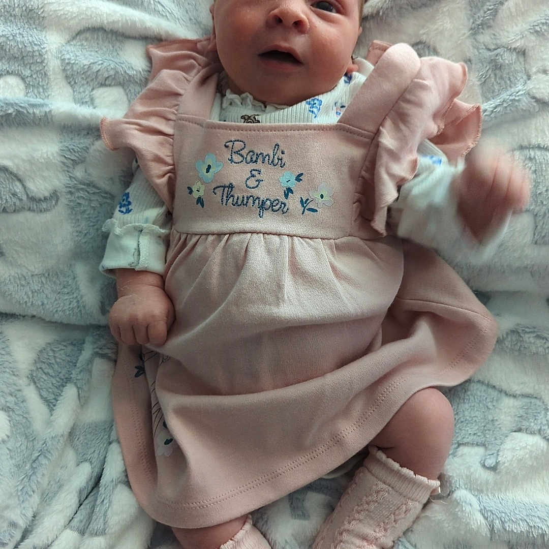 Scarlet Louise joined the competition — help win amazing prizes! baby, blanket, child, clothing, comfort, cute, expression, face, indoors, infant, knitted_socks, lying_down, pacifier, pink_dress, portrait, resting, small_feet, small_hands, soft_texture, young_child