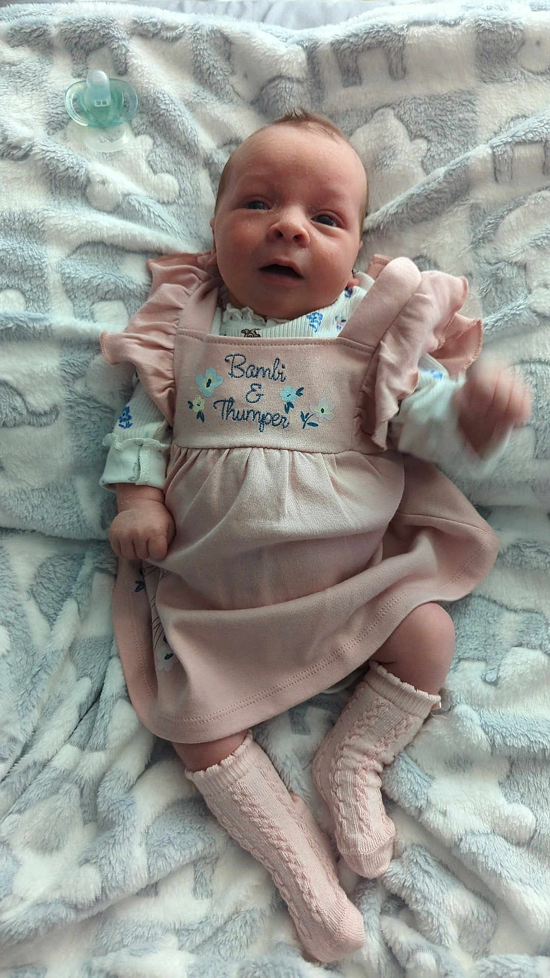 Scarlet Louise joined the competition — help win amazing prizes! baby, blanket, child, clothing, comfort, cute, expression, face, indoors, infant, knitted_socks, lying_down, pacifier, pink_dress, portrait, resting, small_feet, small_hands, soft_texture, young_child