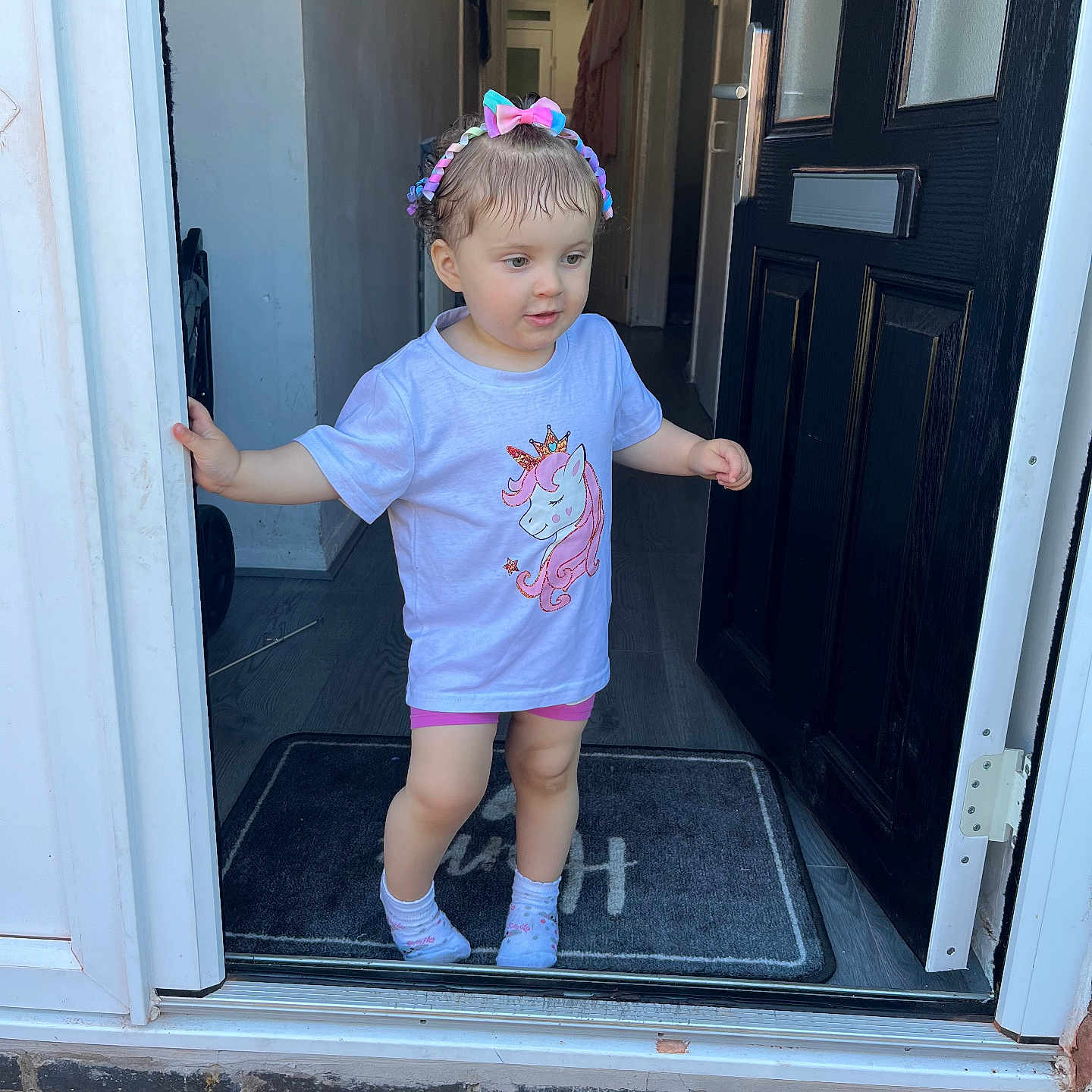 Skyla-Rose joined the competition — help win amazing prizes! casual, child, clothing, curious, cute, door, doorway, floor, hallway, headband, home, indoor, person, portrait, socks, standing, toddler, unicorn_tshirt, welcome_mat, young_child
