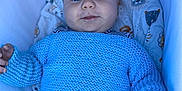 Lino participe au concours pour gagner de l'argent avec cette photo : baby, blue_sweater, infant, face, eyes, knitted_clothing, bassinet, blanket, striped_shirt, cute, child, lying_down, smile, comfort, soft_toys, animal_prints, hand, fingers, young_child, portrait