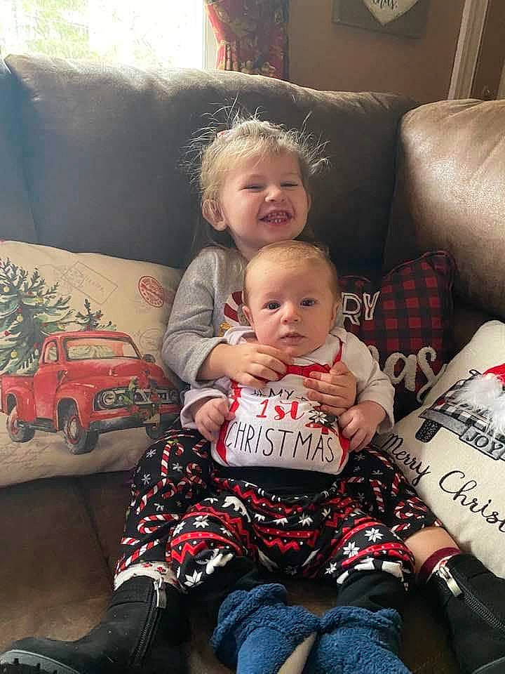 Maeve is registered to the contest to win money with this photo: art, baby, child, christmas_eve, comfort, couch, event, fun, happy, lamp, lap, living_room, person, pillow, room, sitting, smile, t_shirt, tire, toddler