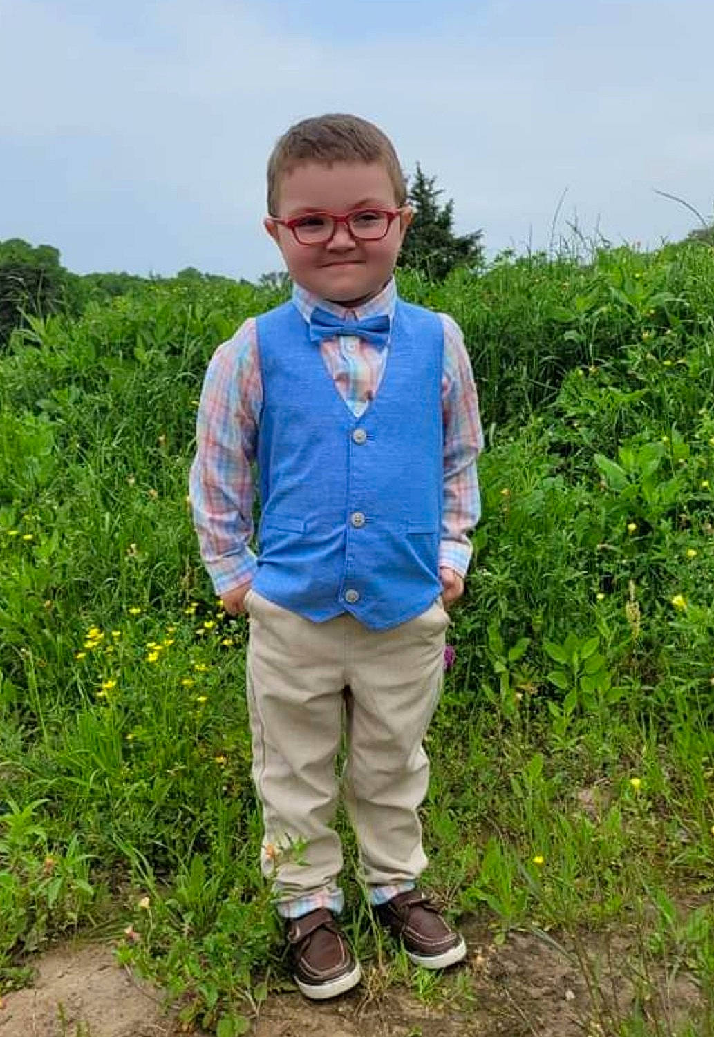 Kyson joined the competition — help win amazing prizes! agriculture, dress_shirt, electric_blue, face, grass, grassland, happy, head, joy, landscape, meadow, people_in_nature, person, plant, prairie, rural_area, sky, sleeve, smile, t_shirt