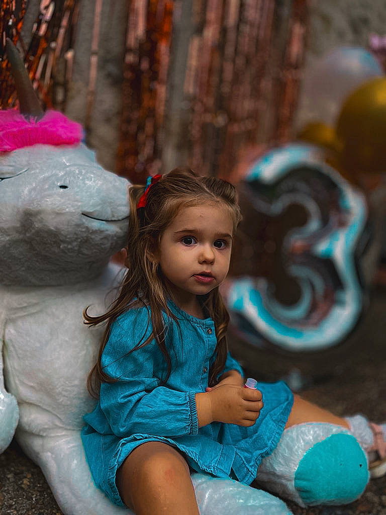 Anastasia a rejoint le concours — aidez-le/la à gagner de superbes lots ! child, electric_blue, face, facial_expression, fawn, fun, fur, grass, happy, leisure, organ, person, pink, play, portrait_photography, recreation, sitting, t_shirt, toddler, toy