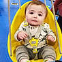 Bennett joined the competition — help win amazing prizes! baby, child, swing, yellow_swing, indoor_play_area, blue_floor, socks, shirt, play_tunnel, toy, child_safety_harness, person, playground, indoor, play, floor_mat, toddler, seat, rope, fun