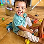barefoot, bright, casual_clothing, child, colorful, curly_hair, cute, floor_tiles, fun, happy, home, indoor, person, playing, playtime, smiling, stacking_cups, toddler, toys, young_child