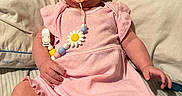 Brinley joined the competition — help win amazing prizes! baby, beads, bed, bow, child, comfort, cute, daisy, hand, headband, indoors, infant, legs, pacifier, pillow, pink_clothing, portrait, romper, skin, sleepwear