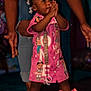 Leilani is registered to the contest to win money with this photo: toddler, child, pink_dress, bows, clapping_hands, shoes, adult_hands, standing, smiling, indoor, colorful_clothing, cartoon_characters, happy, supporting, cute, fashion, celebration, joy, hair_bows, footwear