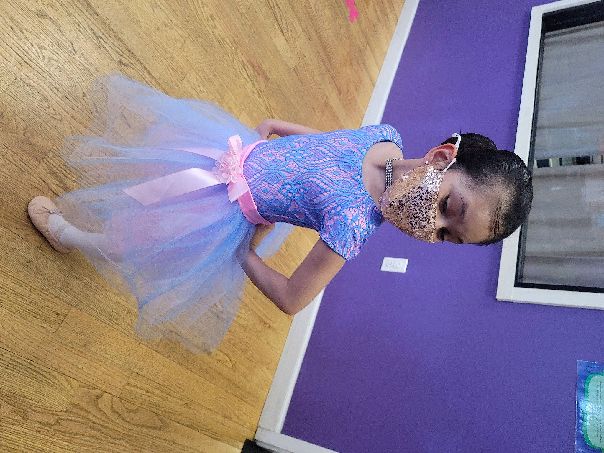 Isabella is registered to the contest to win money with this photo: child, dress, elbow, electric_blue, event, fashion_design, flooring, fun, happy, hardwood, magenta, pattern, person, purple, room, television, window, wood, wood_flooring, wood_stain