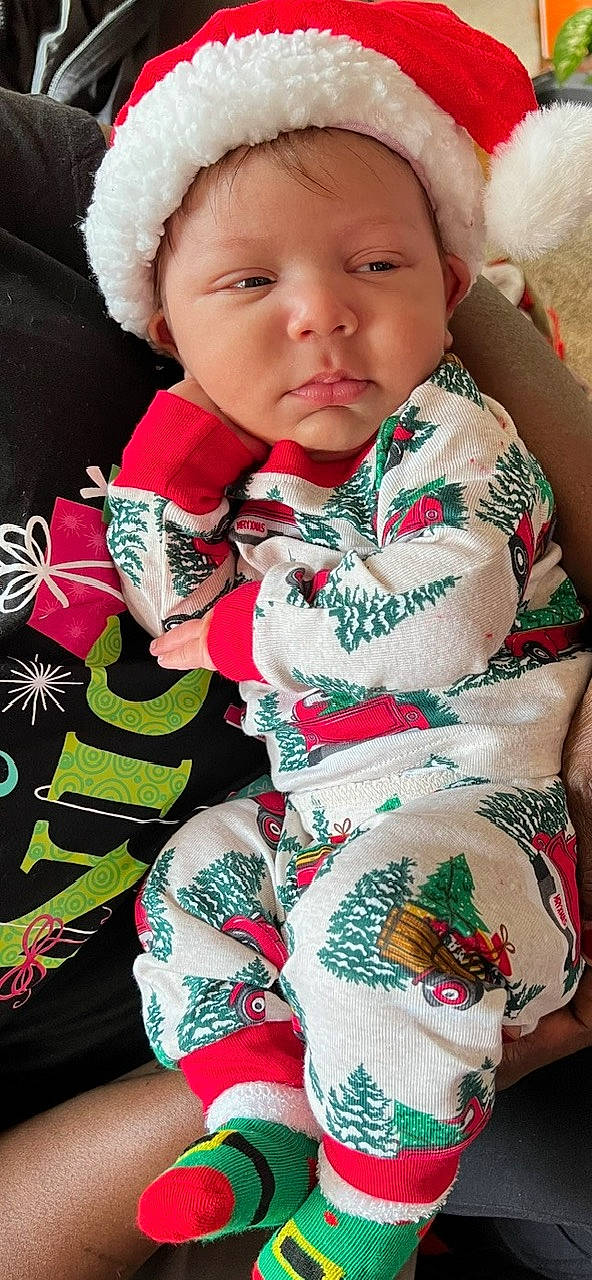 Cannon is registered to the contest to win money with this photo: baby, baby_toddler_clothing, beauty, cheek, child, dress, event, finger, green, happy, headwear, linens, organ, pattern, person, pink, red, skin, sleeve, textile