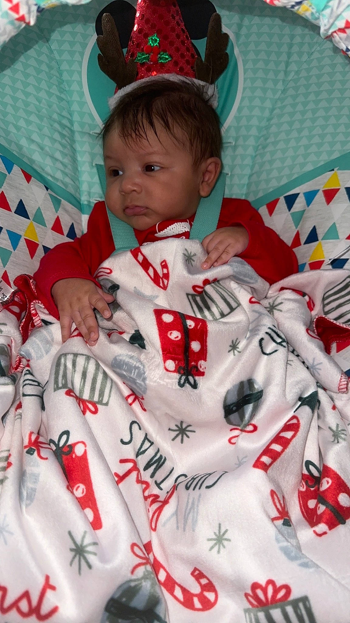 Cannon is registered to the contest to win money with this photo: baby, baby_toddler_clothing, carmine, child, christmas, christmas_eve, event, font, happy, holiday, linens, pattern, person, red, room, sleeve, t_shirt, textile, toddler, uniform