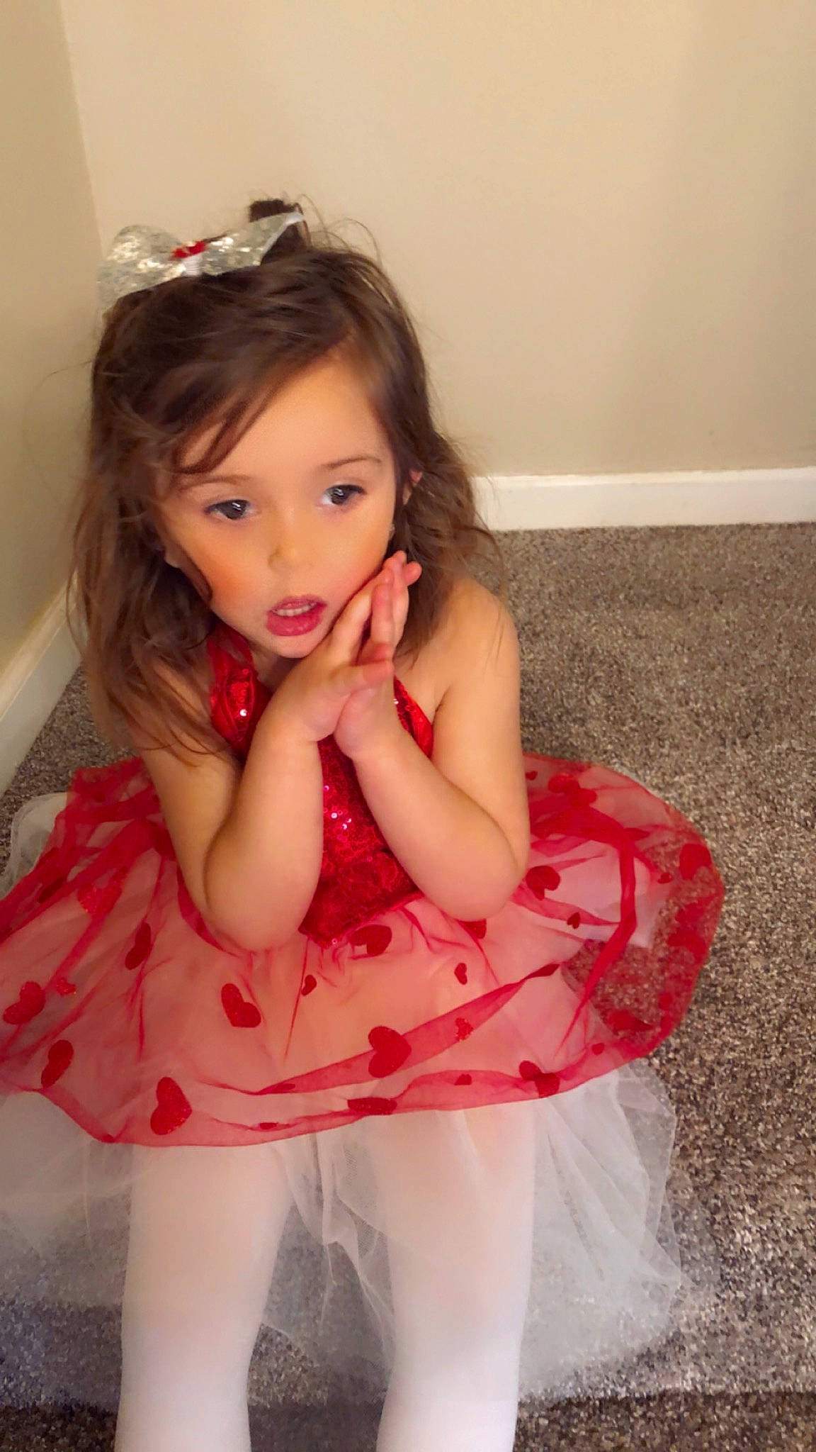 Sophia is registered to the contest to win money with this photo: arm, baby_toddler_clothing, cheek, dress, eye, eyelash, face, flash_photography, hair, hand, happy, head, human_body, iris, lip, neck, person, pink, shoulder, skin