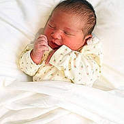 Aurora Escobedo is registered to the contest to win money with this photo: newborn, baby, infant, sleeping, portrait, face, closed_eyes, hand, fist, onesie, floral, clothing, blanket, bedding, white, indoors, peaceful, cute, resting, photography