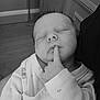 baby, sleeping, infant, hand, finger, pajamas, koala_pattern, cute, peaceful, face, portrait, black_and_white, hair, indoors, wood_floor, clothing, person, newborn, rest, quiet