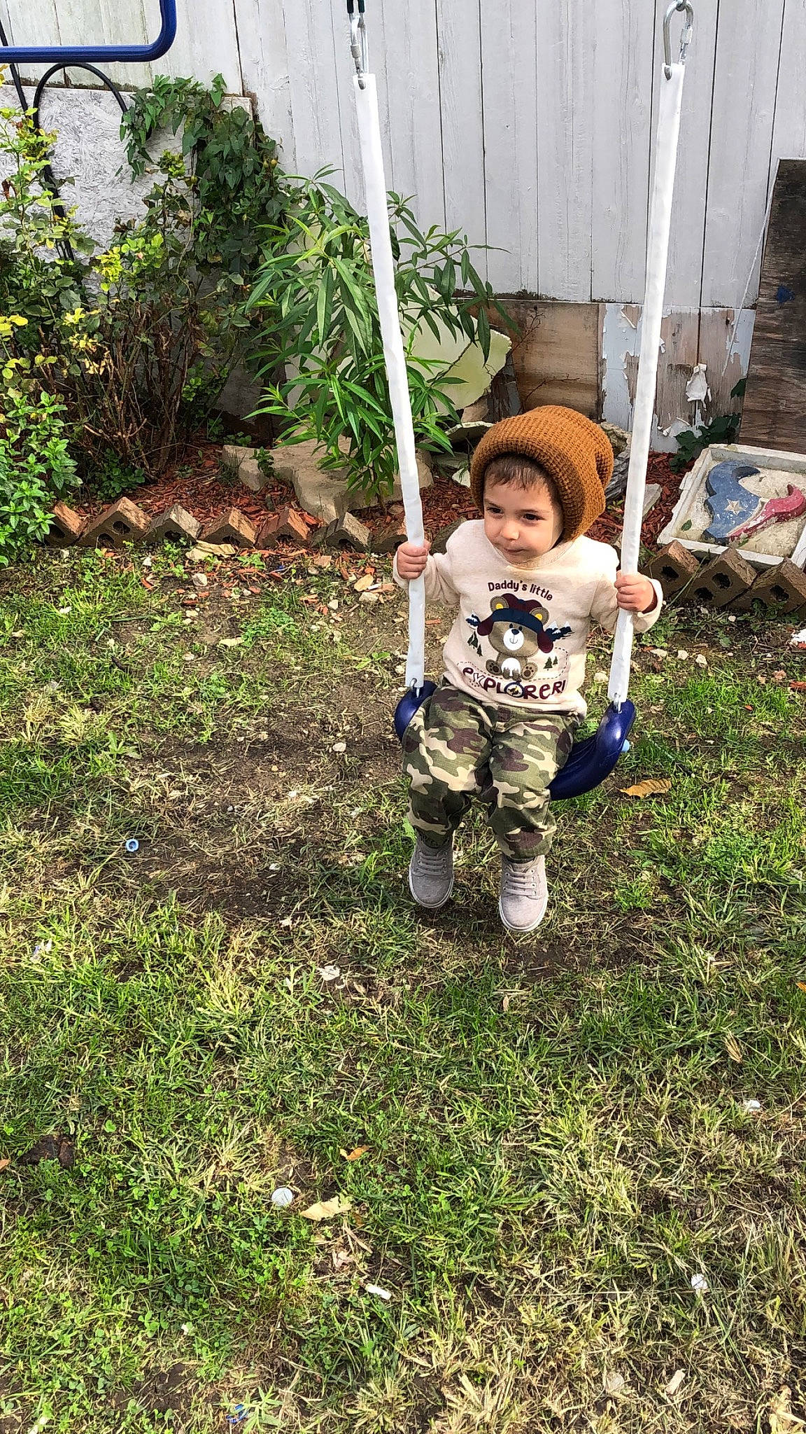 Enzo is registered to the contest to win money with this photo: grass, outdoor_play_equipment, person, plant, swing, toddler, tree, yard