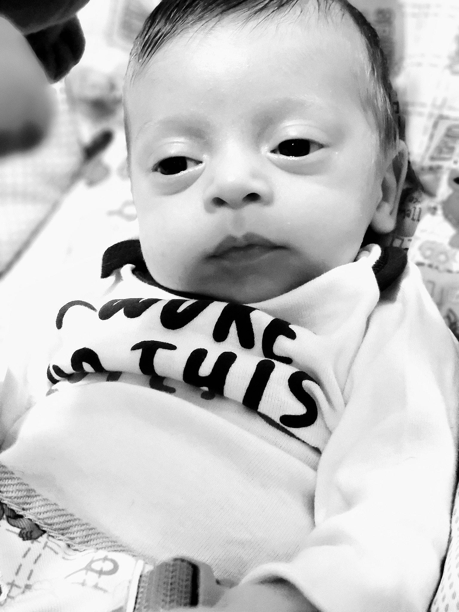 Leander is registered to the contest to win money with this photo: baby, baby_toddler_clothing, black_and_white, cheek, cool, eyebrow, eyelash, flash_photography, hairstyle, happy, iris, nose, outerwear, person, photograph, skin, sleeve, smile, style, toddler