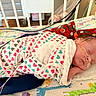 baby, bed, blanket, child, crib, cute, face, giraffe_pattern, healthcare, heart_pattern, hospital, indoor, infant, medical_tubes, newborn, onesie, person, pillow, resting, sleeping