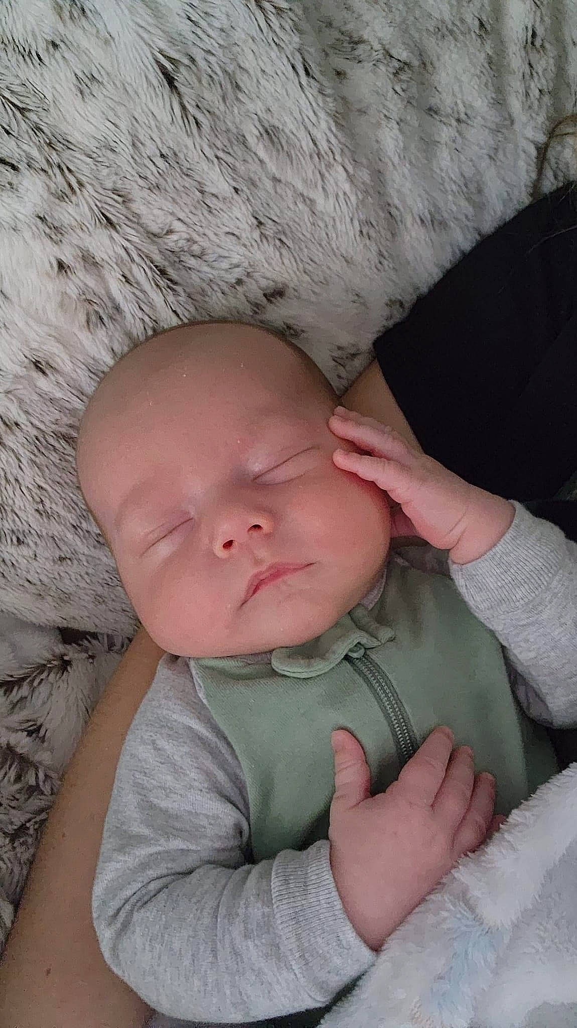Kashton is registered to the contest to win money with this photo: baby, baby_toddler_clothing, cheek, child, chin, comfort, elbow, eye, finger, fun, gesture, hand, iris, linens, mouth, nose, person, sitting, skin, thumb