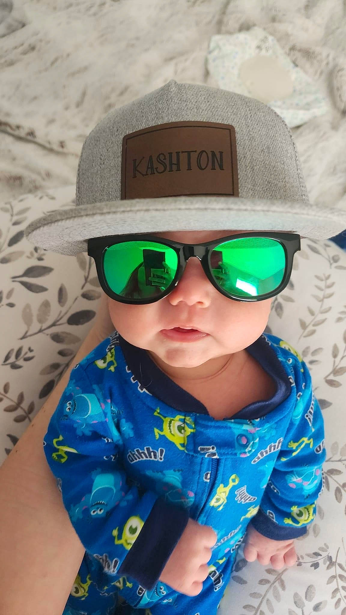 Kashton is registered to the contest to win money with this photo: baby_toddler_clothing, blue, cap, clothing, cool, eyewear, glasses, goggles, happy, hat, head, headgear, headwear, light, lip, person, photograph, sleeve, sun_hat, sunglasses