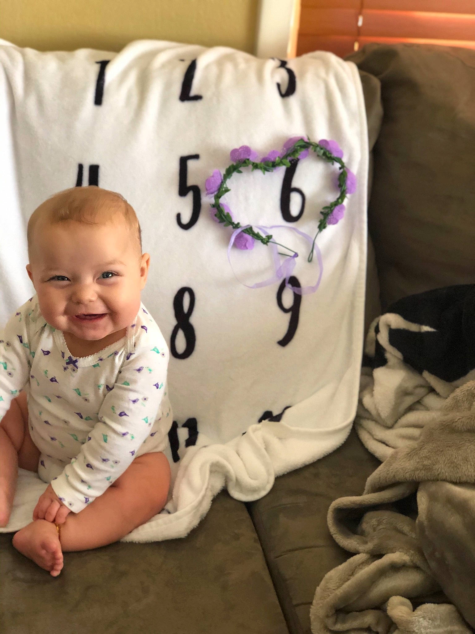 Kaelyn is registered to the contest to win money with this photo: baby, baby_toddler_clothing, bedding, child, comfort, couch, font, fun, happy, linens, pattern, person, pillow, sleeve, smile, t_shirt, textile, throw_pillow, toddler, vertebrate