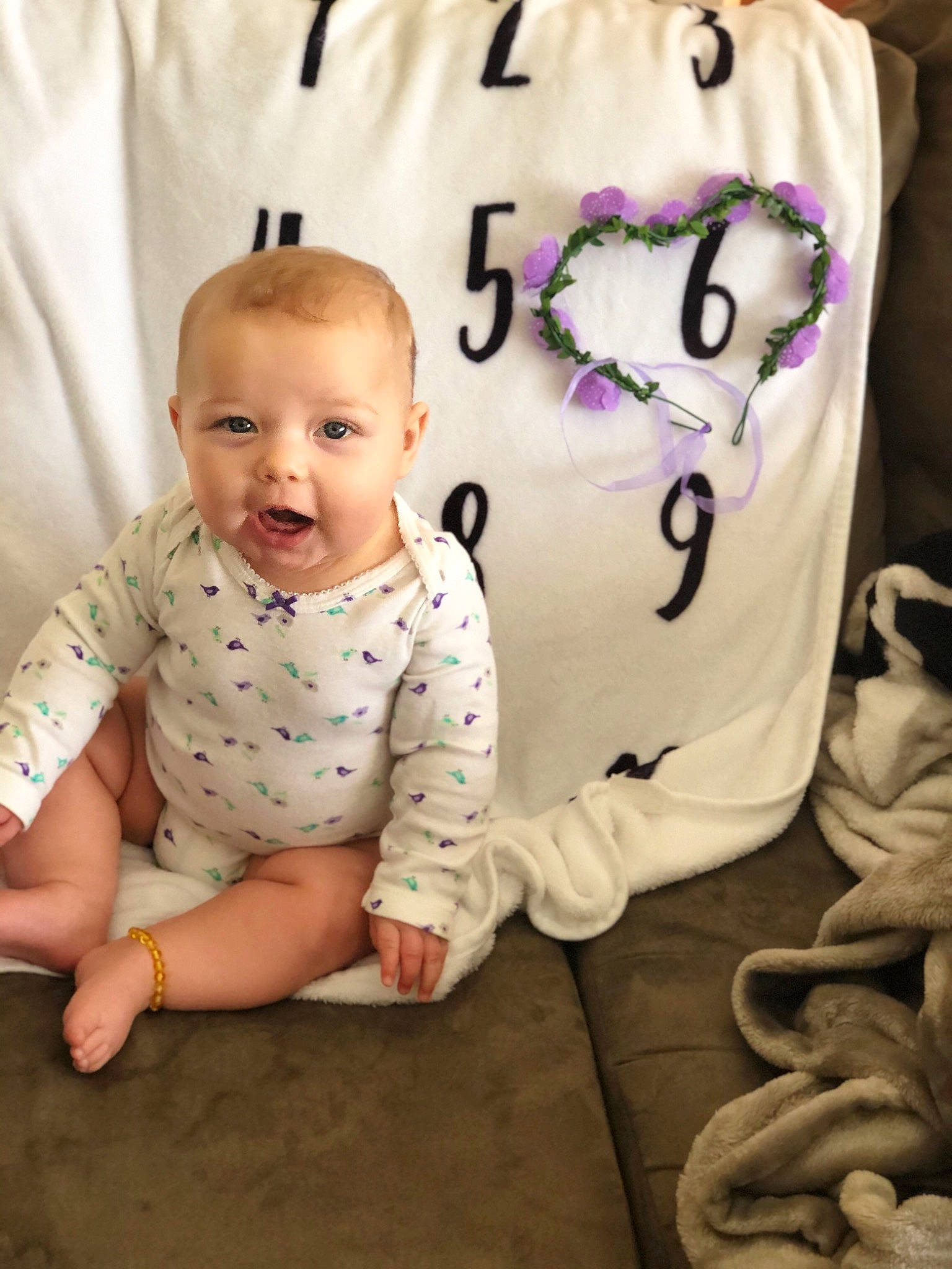 Kaelyn is registered to the contest to win money with this photo: arm, baby, baby_toddler_clothing, banana, cheek, finger, happy, head, human, mammal, organ, person, photograph, pink, product, skin, sleeve, smile, textile, vertebrate