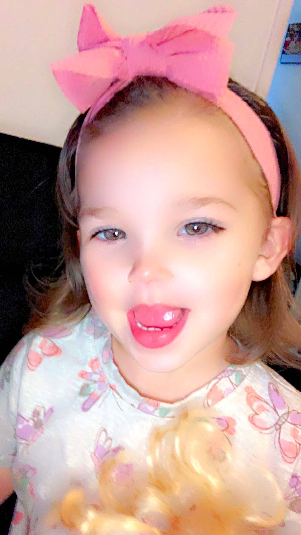 Madilyn Grace is registered to the contest to win money with this photo: cheek, chin, ear, eyebrow, eyelash, forehead, fun, happy, headgear, iris, jaw, lip, mouth, neck, nose, person, pink, skin, smile, toddler