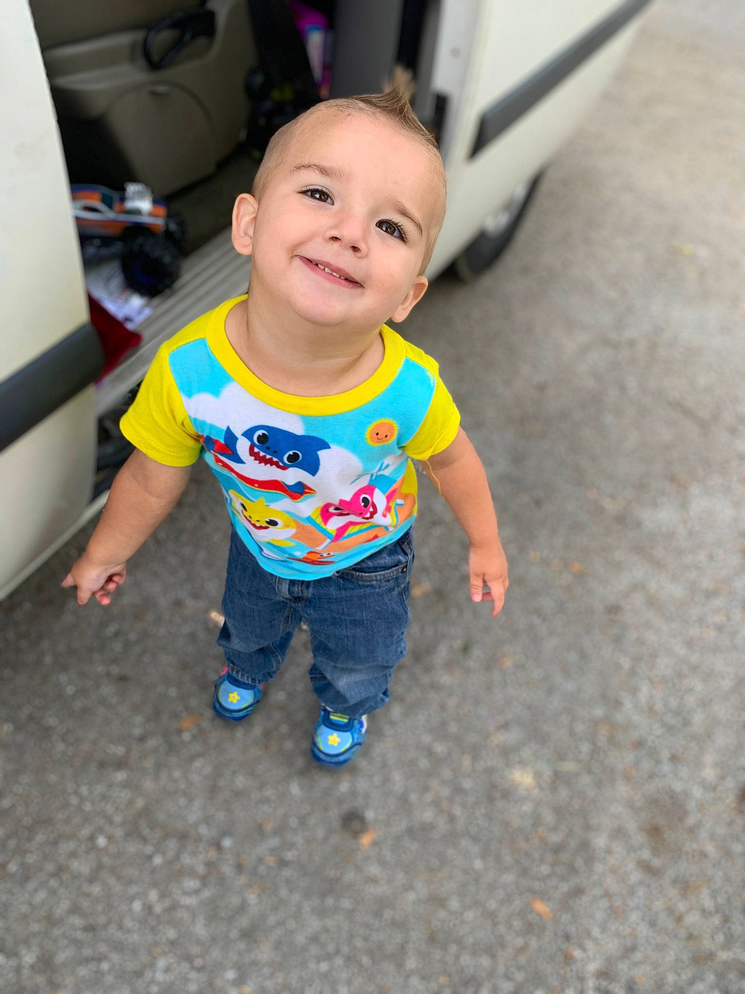 David is registered to the contest to win money with this photo: arm, asphalt, baby, baby_toddler_clothing, chair, child, eye, floor, flooring, fun, happy, head, joy, leg, person, play, sitting, skin, sleeve, smile