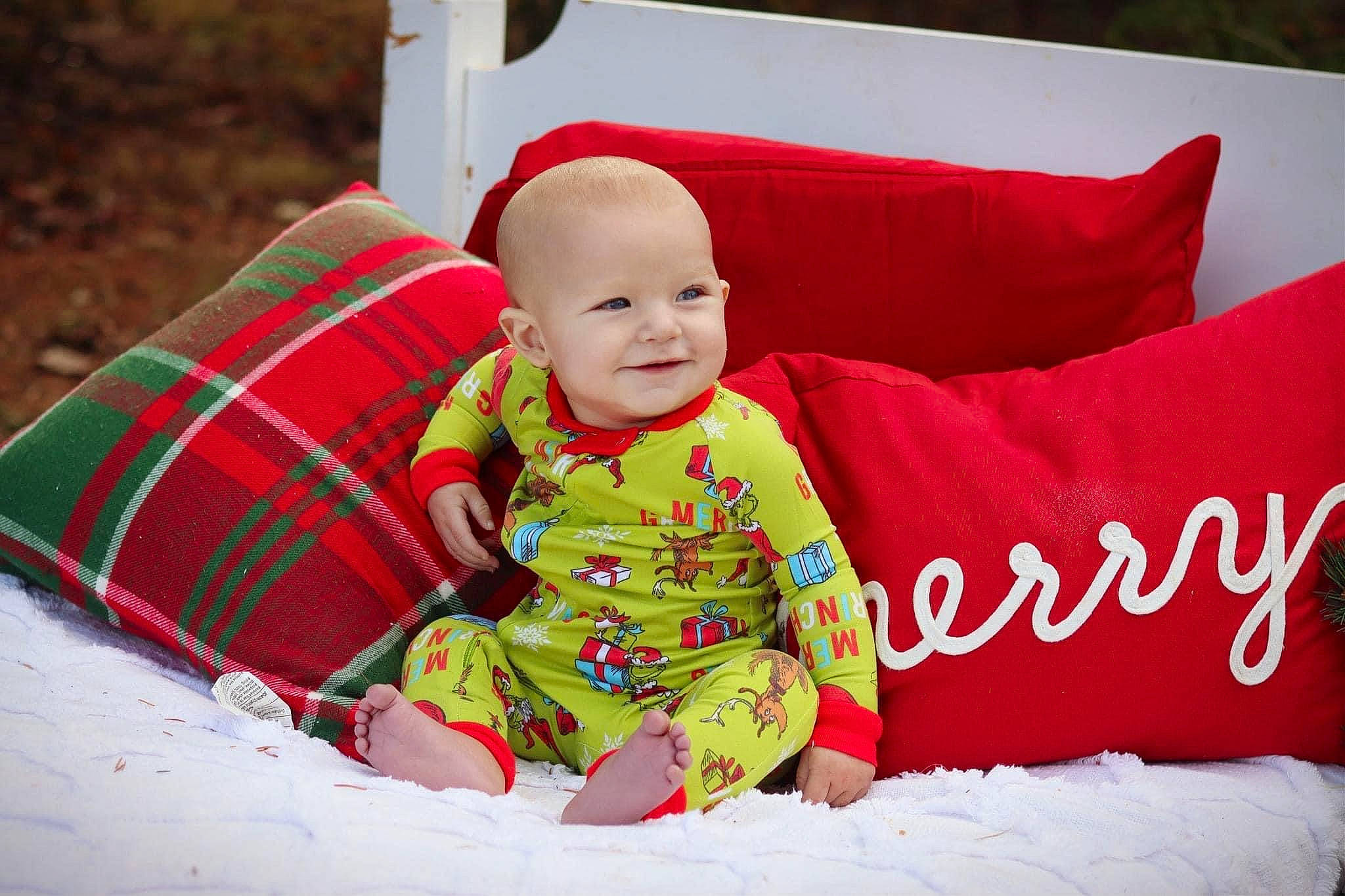 Johnny is registered to the contest to win money with this photo: baby, baby_toddler_clothing, child, comfort, fun, grass, happy, holiday, joy, linens, magenta, person, pillow, plaid, sitting, sleeve, smile, t_shirt, tartan, textile