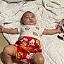 Hadley is registered to the contest to win money with this photo: baby, infant, blanket, white_blanket, floor, red_shorts, cute_clothing, minnie_mouse, cartoon_shirt, lying_down, arms_outstretched, barefoot, indoor, child, baby_face, curious_expression, patterned_clothing, colorful_shorts, soft_texture, comfort