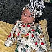 Hadley joined the competition — help win amazing prizes! baby, infant, pajamas, christmas_theme, headband, bow, blanket, bottle, medicine, sitting, indoors, curious_expression, furniture, shelf, holiday, cute, child, person, portrait, clothing