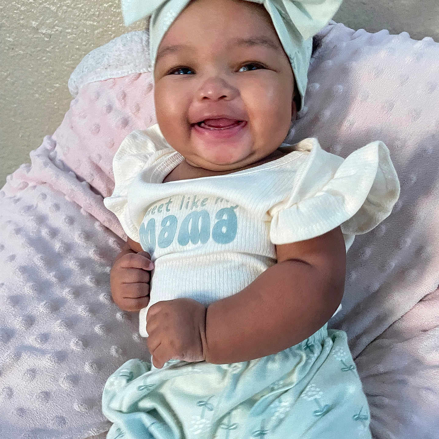 Emari is registered to the contest to win money with this photo: baby, blanket, bow, cheerful, child, clothing, cute, furniture, happy, headband, indoors, infant, pastel, person, portrait, sitting, skin, smiling, soft, young