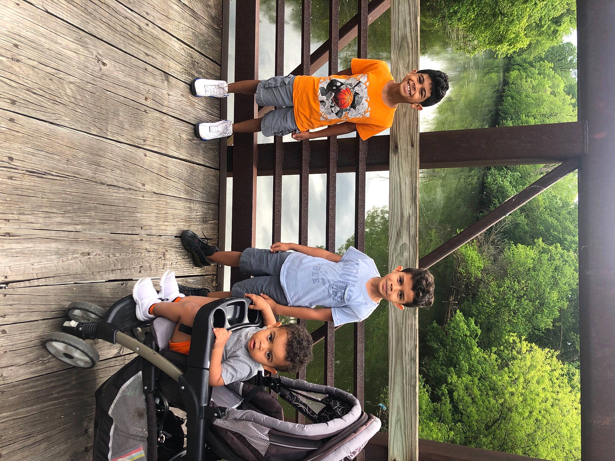 Noah is registered to the contest to win money with this photo: backpack, door, facade, fun, green, hat, joy, leisure, luggage_and_bags, metal, person, plant, porch, shorts, surprise, t_shirt, travel, tree, wood, yellow