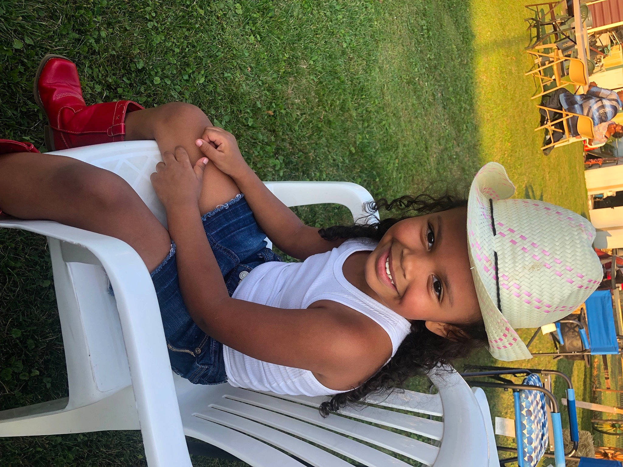 Izabella is registered to the contest to win money with this photo: comfort, cool, elbow, facial_expression, fun, grass, happy, hat, headwear, human_body, human_leg, joint, joy, knee, leisure, muscle, person, shorts, smile, summer