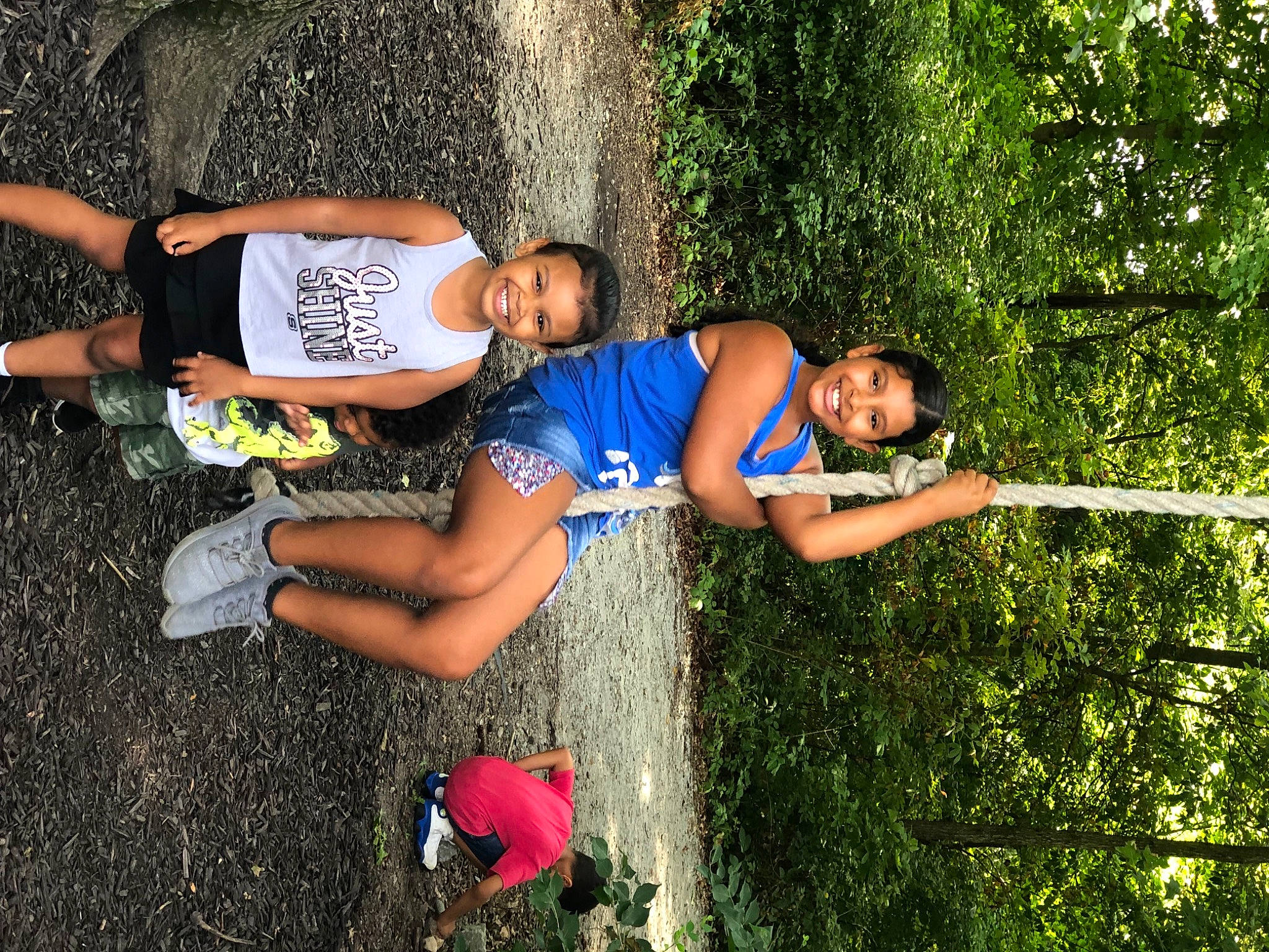 Tianna is registered to the contest to win money with this photo: arm, calf, electric_blue, fun, grass, happy, human_leg, joy, knee, leisure, people_in_nature, person, plant, recreation, shorts, smile, sportswear, t_shirt, thigh, tree