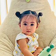Carmel joined the competition — help win amazing prizes! toddler, child, pigtails, toy, bean_bag, plush, indoor, portrait, cute, curious, flower_pattern, clothing, furniture, face, person, young_child, comfortable, natural_light, home, seated