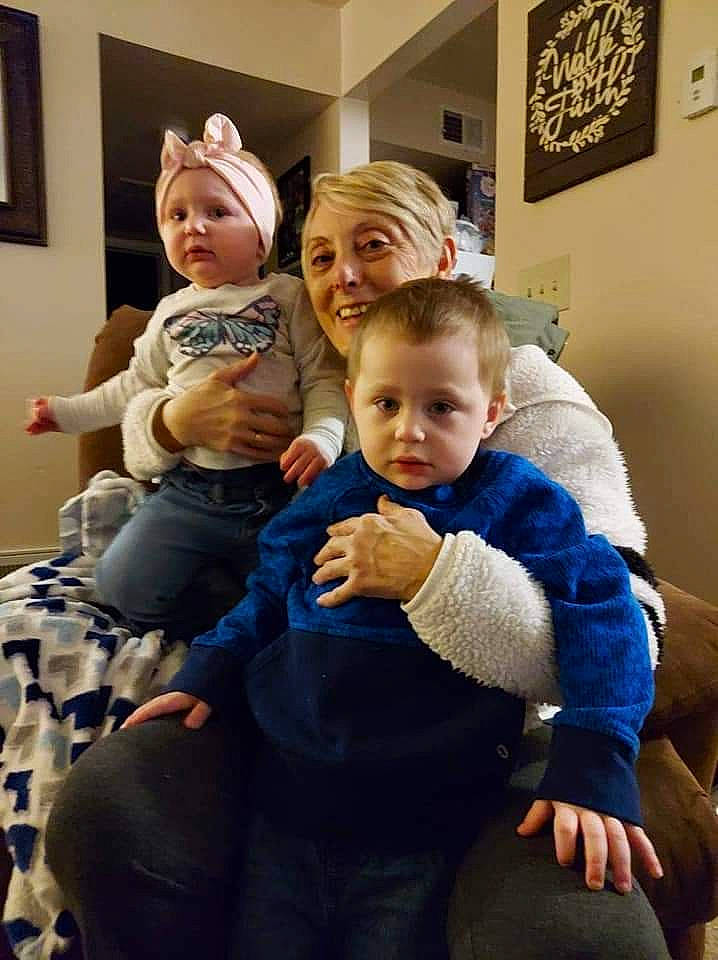 Carley is registered to the contest to win money with this photo: baby, baby_toddler_clothing, child, comfort, couch, event, fun, gesture, happy, hat, headwear, human_body, interaction, iris, joy, lap, living_room, person, picture_frame, shoulder